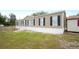 Tan mobile home with black shutters and yard at 3046 Crystal Hills Dr, Lakeland, FL 33801