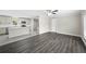 Open living room and kitchen with grey vinyl plank flooring at 3046 Crystal Hills Dr, Lakeland, FL 33801