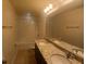 This bathroom features double sinks, granite countertops, and tiled floors at 745 Marsh Reed Dr, Winter Garden, FL 34787