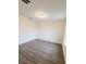 This bedroom features wood-look flooring and a large window that offers plenty of natural light at 745 Marsh Reed Dr, Winter Garden, FL 34787
