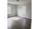 Bedroom featuring new wood floors, freshly painted walls, and bright windows at 745 Marsh Reed Dr, Winter Garden, FL 34787
