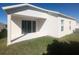 An ample-sized concrete back patio with sliding glass doors into the home at 478 Disa Dr, Davenport, FL 33837