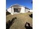 House's backyard features a covered patio and grassy area at 478 Disa Dr, Davenport, FL 33837