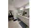 Double vanity bathroom with a walk-in shower and granite countertops at 478 Disa Dr, Davenport, FL 33837