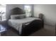 Bedroom showcasing a stately dark wood bed frame and ample natural light from large windows at 478 Disa Dr, Davenport, FL 33837