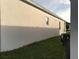 View of the home's exterior, showing the yard and side of the home at 478 Disa Dr, Davenport, FL 33837