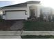 Charming one-story home with a well-manicured lawn, a brick driveway, and a welcoming entrance at 478 Disa Dr, Davenport, FL 33837