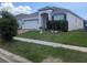 Exterior view of a well-maintained home with a manicured lawn and a neat front garden at 478 Disa Dr, Davenport, FL 33837