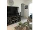 Bright living room featuring large TV, comfy seating, and decorative plants at 478 Disa Dr, Davenport, FL 33837