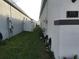 Landscaped side yard featuring lush green lawn, garden beds, and a privacy fence, enhancing the outdoor space at 478 Disa Dr, Davenport, FL 33837