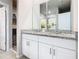 Double vanity with granite countertops and white cabinets at 3052 Cassidy Ln, Haines City, FL 33844