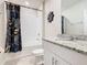 Clean bathroom with a shower/tub combo and granite countertop at 3052 Cassidy Ln, Haines City, FL 33844