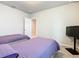 Two twin beds in a bedroom with TV and access to another room at 3052 Cassidy Ln, Haines City, FL 33844