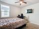 Spacious bedroom with a large bed and wall-mounted TV at 3052 Cassidy Ln, Haines City, FL 33844