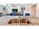 Modern kitchen with double sink, granite countertops, and stainless steel faucet at 3052 Cassidy Ln, Haines City, FL 33844