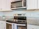 Modern kitchen with stainless steel appliances and granite countertops at 3052 Cassidy Ln, Haines City, FL 33844