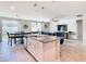 Open kitchen with island, granite counters, stainless steel appliances, and breakfast bar at 3052 Cassidy Ln, Haines City, FL 33844