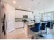 Modern kitchen with white cabinets, granite counters, and stainless steel appliances at 3052 Cassidy Ln, Haines City, FL 33844