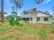 Back of house with a screened patio and large backyard at 2226 Baker Ave, Orlando, FL 32833