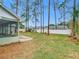 Large backyard with a screened porch and tall trees at 2226 Baker Ave, Orlando, FL 32833