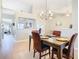 Dining room with hardwood floors, a chandelier, and views of the living room at 2226 Baker Ave, Orlando, FL 32833