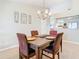 Bright dining room with wood table and four chairs, offering a view into the kitchen at 2226 Baker Ave, Orlando, FL 32833