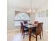 Dining room with hardwood floors, a chandelier, and an arched window at 2226 Baker Ave, Orlando, FL 32833