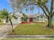 One-story house with a green exterior, red door, and attached garage at 2226 Baker Ave, Orlando, FL 32833