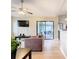 Bright living room with hardwood floors, fireplace, and sliding glass doors leading to a patio at 2226 Baker Ave, Orlando, FL 32833