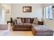 Living area with L-shaped sectional sofa and hardwood floors at 2226 Baker Ave, Orlando, FL 32833