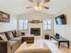 Spacious living room with L-shaped sofa, fireplace and hardwood floors at 2226 Baker Ave, Orlando, FL 32833