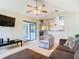 Living room with hardwood floors, open concept to kitchen, and patio access at 2226 Baker Ave, Orlando, FL 32833