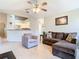 Living room with hardwood floors, open concept to kitchen, and ceiling fan at 2226 Baker Ave, Orlando, FL 32833