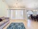 Living room with hardwood floors, a couch, and views into the dining area at 2226 Baker Ave, Orlando, FL 32833