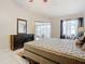 Main bedroom with king-size bed, dresser, and sliding glass door to patio at 2226 Baker Ave, Orlando, FL 32833