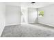 Spacious, bright bedroom with new gray carpet and two sunny windows overlooking a large lawn at 5431 9Th Se St, Lakeland, FL 33812
