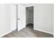 Bedroom with newly installed gray floors, two white doors, and light gray walls throughout at 5431 9Th Se St, Lakeland, FL 33812