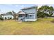 Two-story home showcasing a cozy screened porch and a spacious grassy yard at 5431 9Th Se St, Lakeland, FL 33812