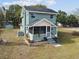 Charming two-story home with light-blue siding, a screened porch, and manicured landscaping at 5431 9Th Se St, Lakeland, FL 33812