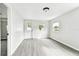 Bright and airy room features modern gray floors, and new light fixtures at 5431 9Th Se St, Lakeland, FL 33812