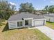 Newly built home with gray roof and driveway at 1305 Congo Ct, Poinciana, FL 34759