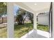 Covered back patio overlooking a fenced backyard with grass at 1305 Congo Ct, Poinciana, FL 34759