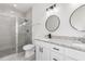 Modern bathroom with double vanity, granite countertop, and glass shower at 1305 Congo Ct, Poinciana, FL 34759