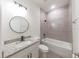 Bathroom with single vanity, granite countertop, and bathtub at 1305 Congo Ct, Poinciana, FL 34759