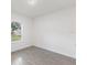 Spacious bedroom with gray tile flooring and large window at 1305 Congo Ct, Poinciana, FL 34759