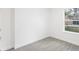 Simple bedroom with gray tile flooring and large window at 1305 Congo Ct, Poinciana, FL 34759