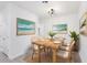 Charming dining area with rustic wooden table and coastal artwork at 1305 Congo Ct, Poinciana, FL 34759