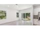 Open concept dining room with wood table and sliding glass doors at 1305 Congo Ct, Poinciana, FL 34759
