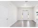 Bright entryway with gray tile floor and white walls at 1305 Congo Ct, Poinciana, FL 34759