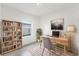 Bright home office features built-in shelving and wood desk at 1305 Congo Ct, Poinciana, FL 34759